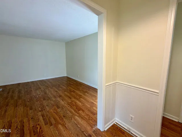 an empty room with wooden floor