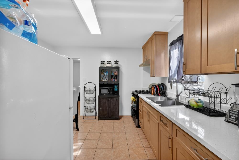 33554 7th Street Union City, CA 94587 - Photo 11 of 38 a kitchen with stainless steel appliances granite countertop a refrigerator and a sink