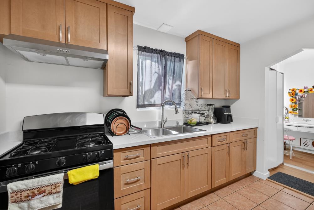 33554 7th Street Union City, CA 94587 - Photo 10 of 38 a kitchen with stainless steel appliances granite countertop a stove a sink and a microwave