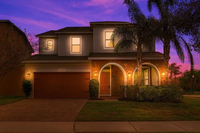 a front view of a house with lots of trees