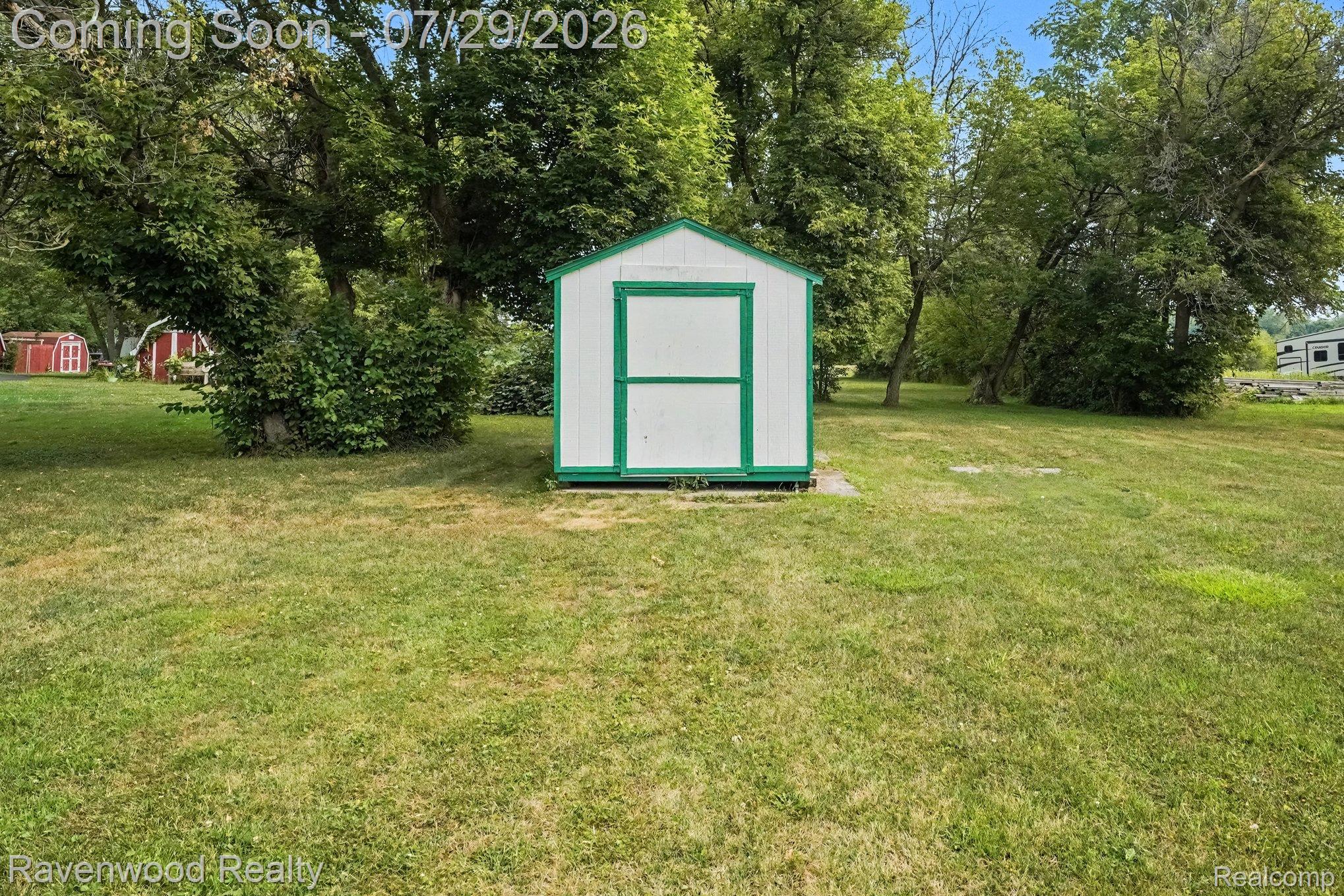 6317 East Coldwater Road Flint, MI 48506 - Photo 26 of 29 White and green storage shed situated on a grassy lawn