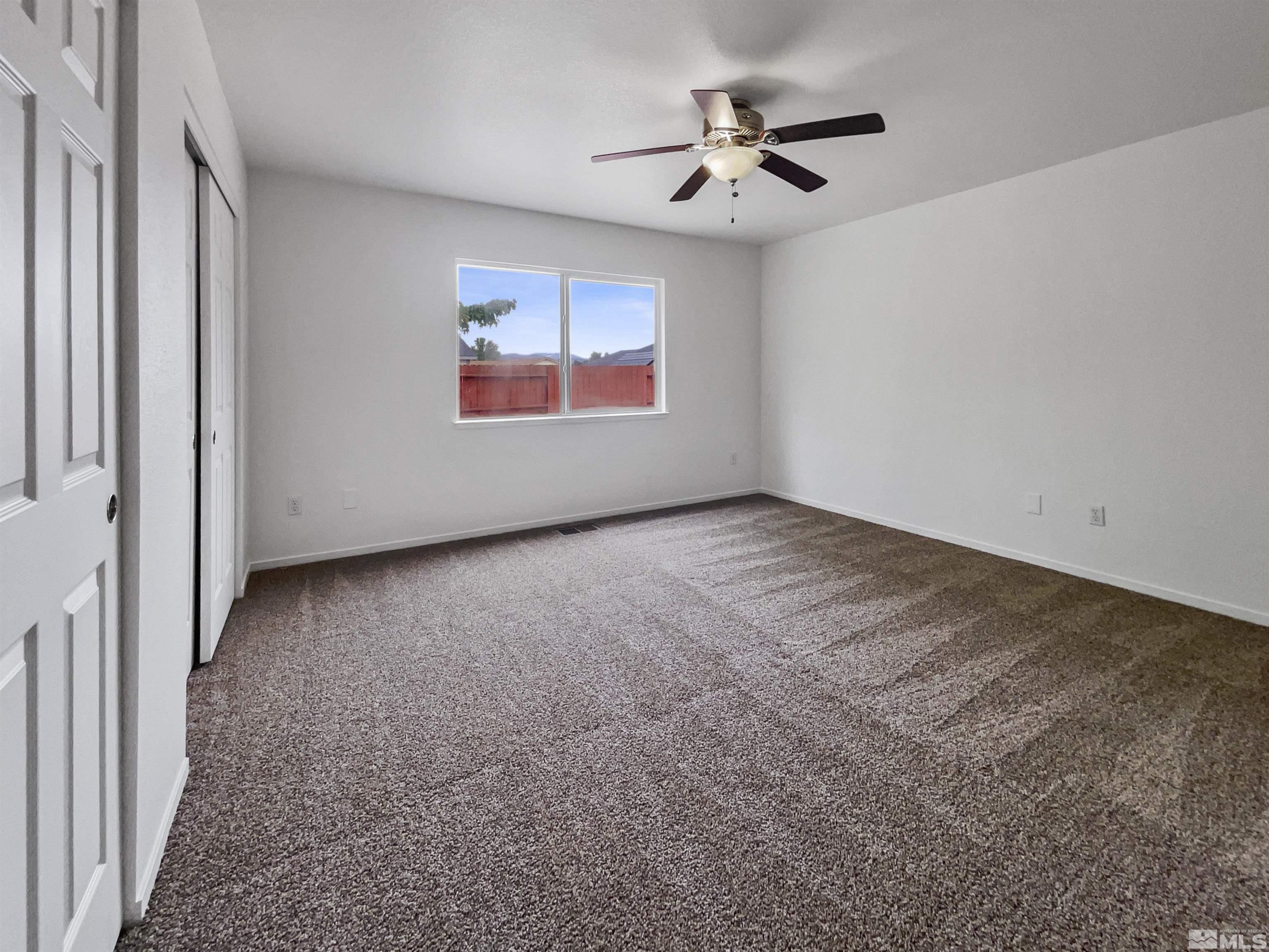 17838 Empire Court Reno, NV 89508 - Photo 5 of 20 an empty room with windows and ceiling fan