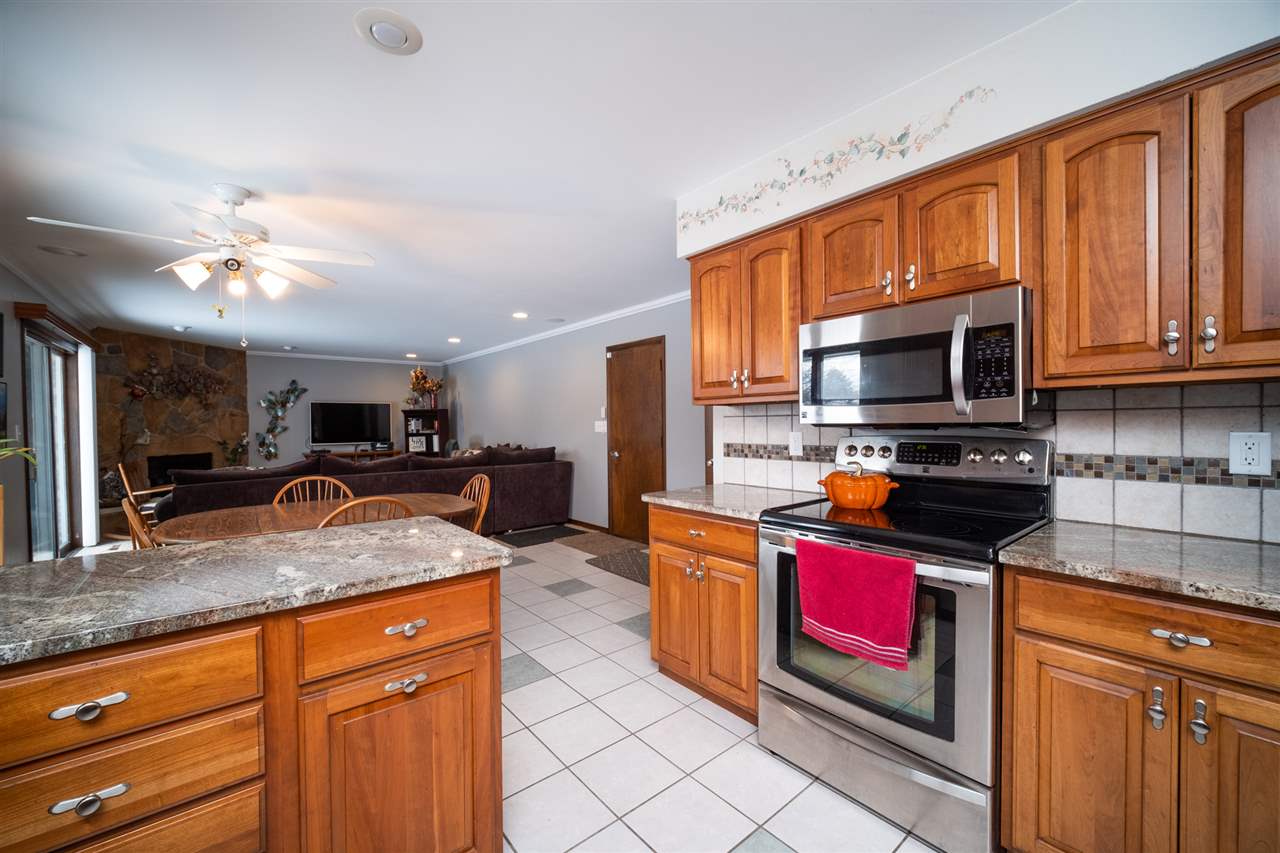 5391 Brookview Road Rockford, IL 61107 - Photo 9 of 33 a kitchen with stainless steel appliances granite countertop a stove sink and microwave