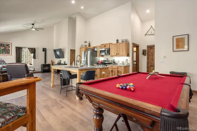a living room with furniture and a pool table