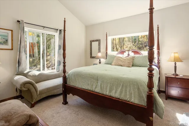 a bedroom with a bed couch and window