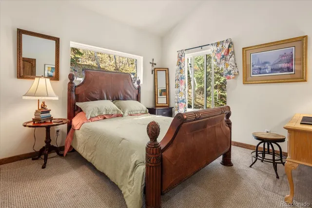 a bedroom with a bed a table and chair