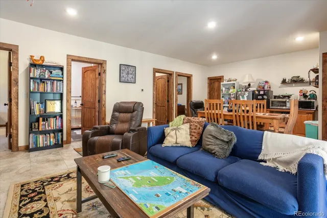 a living room with furniture and a book shelf
