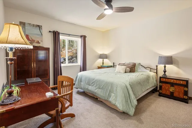 a bedroom with a bed a table and chair