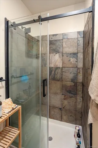 a bathroom with a shower and a sink