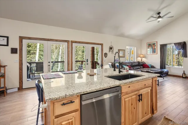 a kitchen with granite countertop stainless steel appliances a sink and cabinets