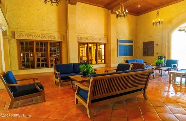 a balcony with furniture and a potted plant