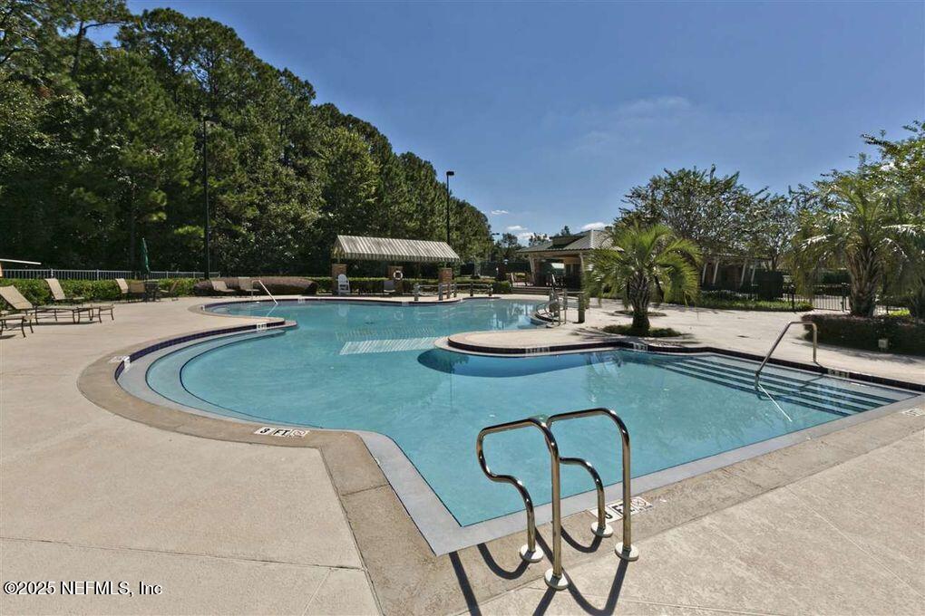 945 Registry Boulevard, Unit 212 St. Augustine, FL 32092 - Photo 20 of 26 a view of a swimming pool with chairs