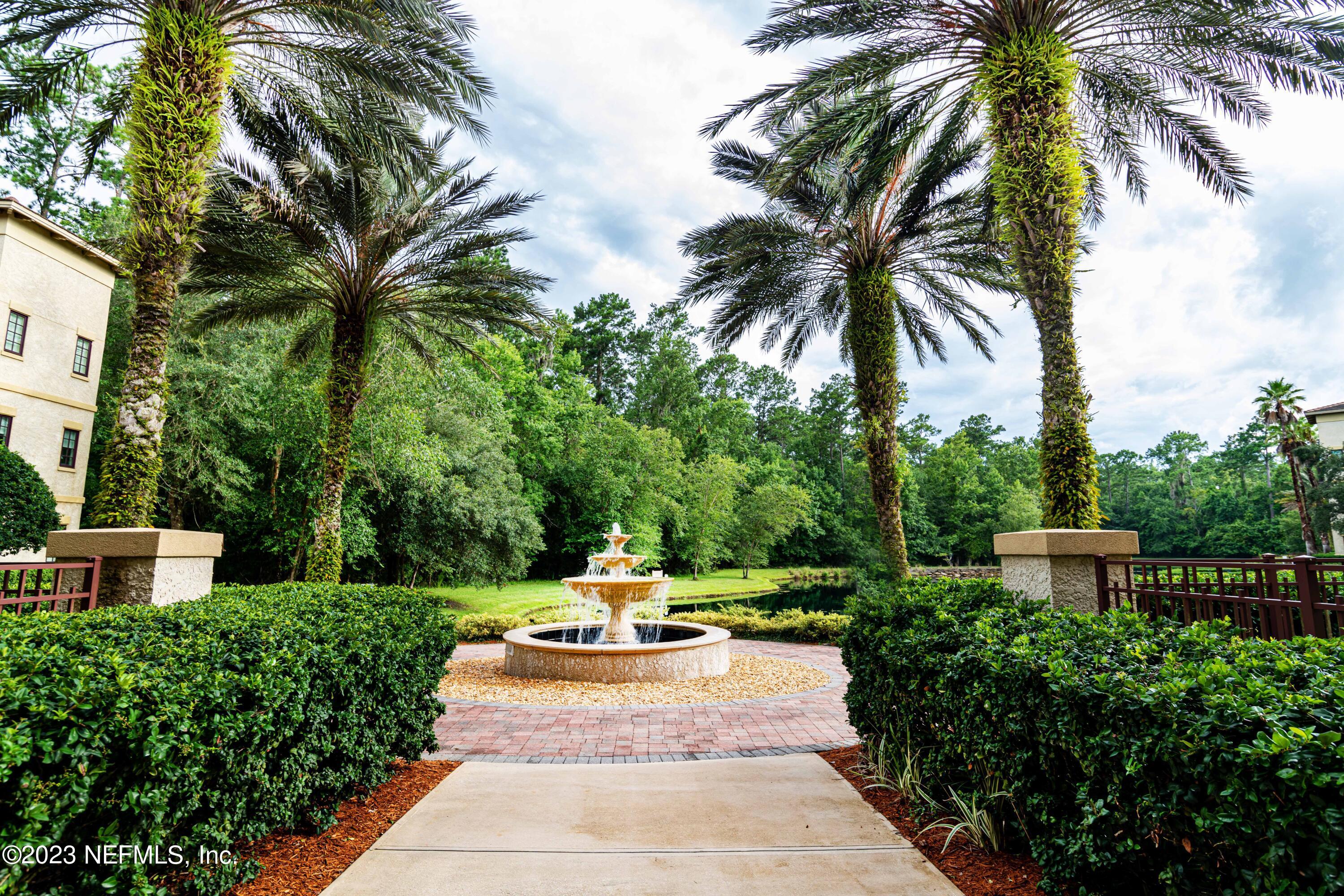945 Registry Boulevard, Unit 212 St. Augustine, FL 32092 - Photo 2 of 26 a view of a swimming pool with a garden