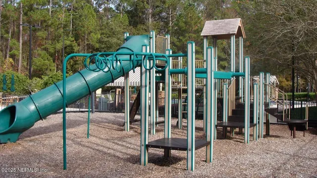 a view of a chair and table in the backyard