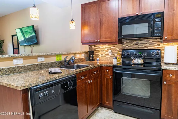 a kitchen with stainless steel appliances granite countertop a stove microwave and oven