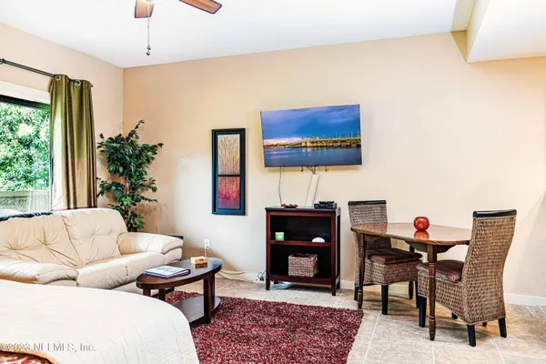 a living room with furniture a rug and a window