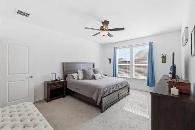 a bedroom with a bed dresser and a window