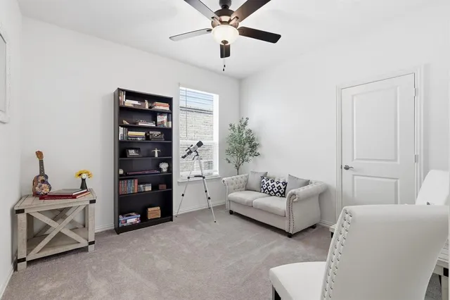 a living room with furniture and white walls