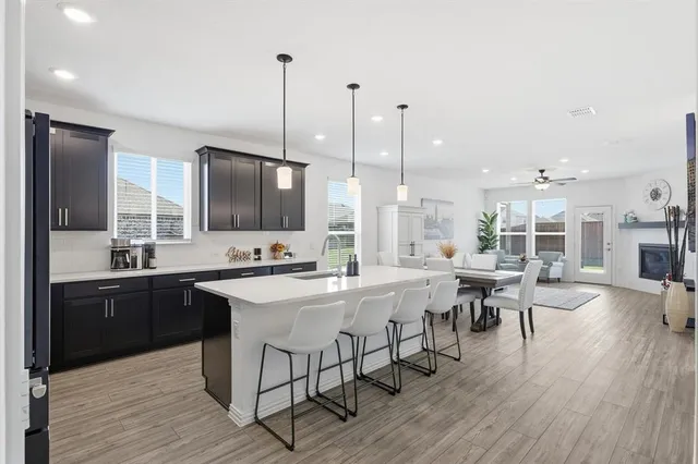 a kitchen with stainless steel appliances kitchen island granite countertop a sink and cabinets