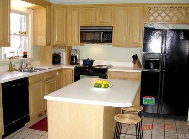 10204 Roadstead Way West Raleigh, NC 27613 - Photo 3 of 7 a kitchen with a sink a stove and cabinets