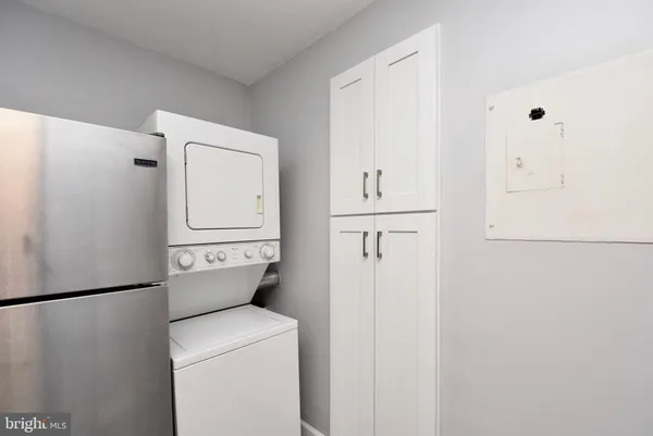 a kitchen with granite countertop white cabinets and stainless steel appliances