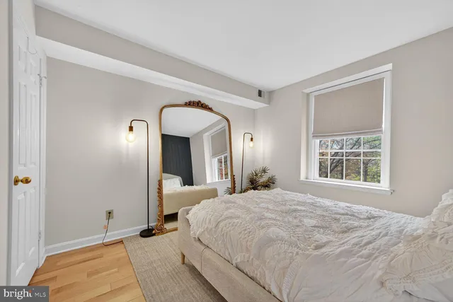 a bedroom with a bed and a large window