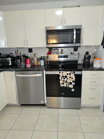 a kitchen with a stove a microwave and refrigerator