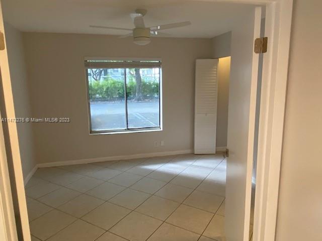 9071 Southwest 141st Place, Unit 9071 Miami, FL 33186 - Photo 6 of 10 an empty room with windows and closet