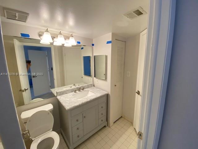 9071 Southwest 141st Place, Unit 9071 Miami, FL 33186 - Photo 7 of 10 a bathroom with a double vanity sink and a mirror