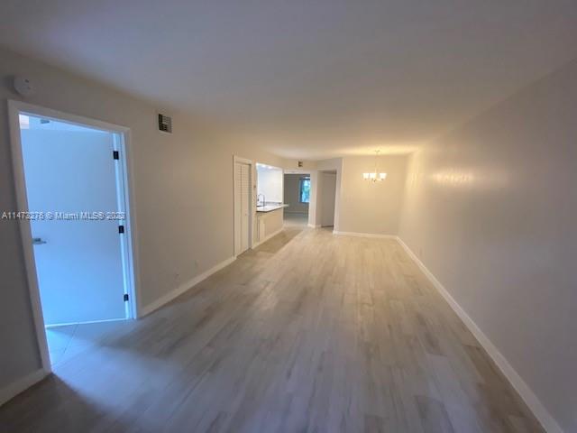 9071 Southwest 141st Place, Unit 9071 Miami, FL 33186 - Photo 8 of 10 wooden floor in an empty room with a window