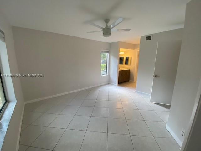 9071 Southwest 141st Place, Unit 9071 Miami, FL 33186 - Photo 9 of 10 a view of an empty room with a window
