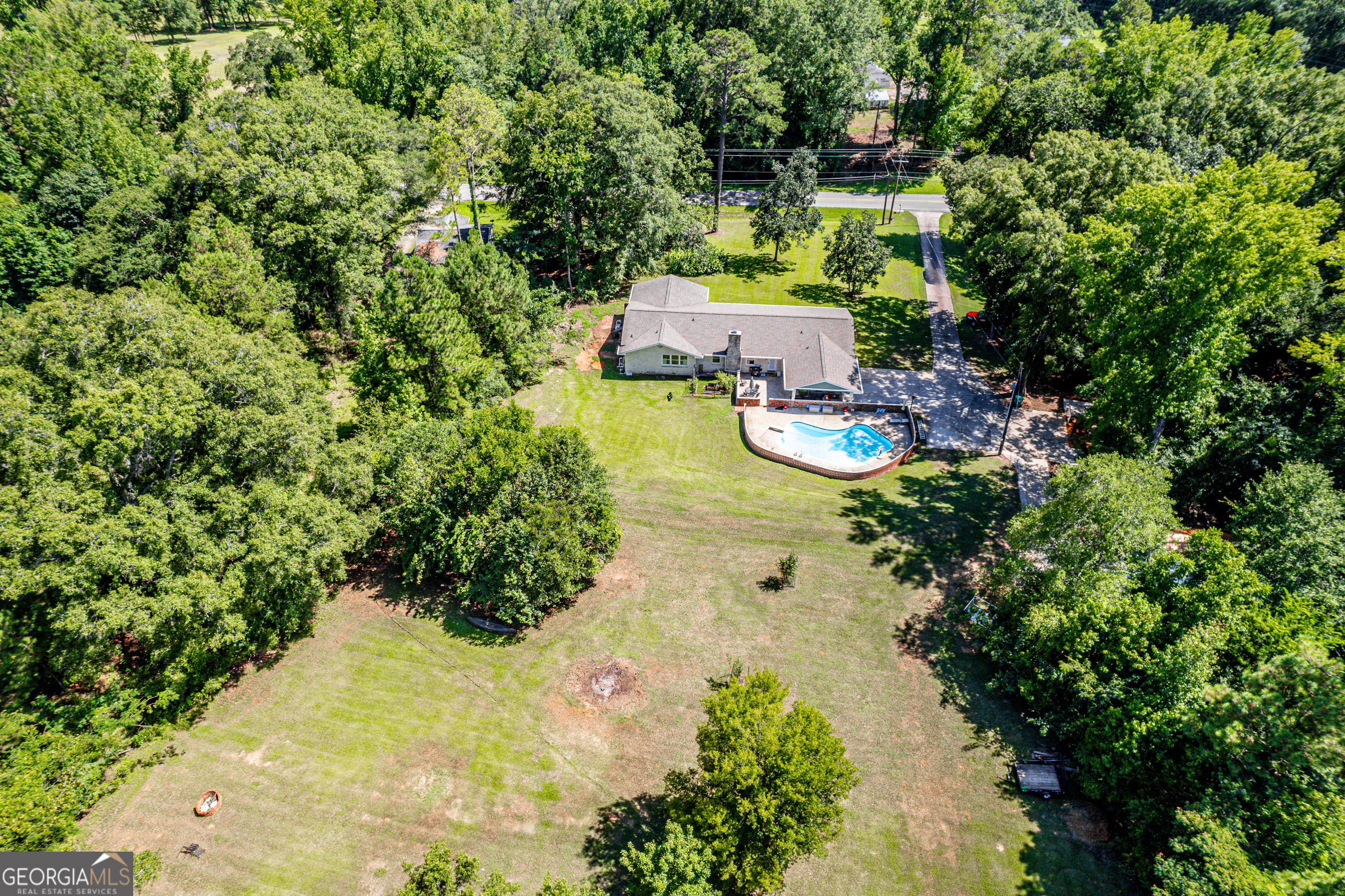122 Ivey Weaver Road Milledgeville, GA 31061 - Photo 13 of 64 a view of a garden with lawn chairs under an umbrella