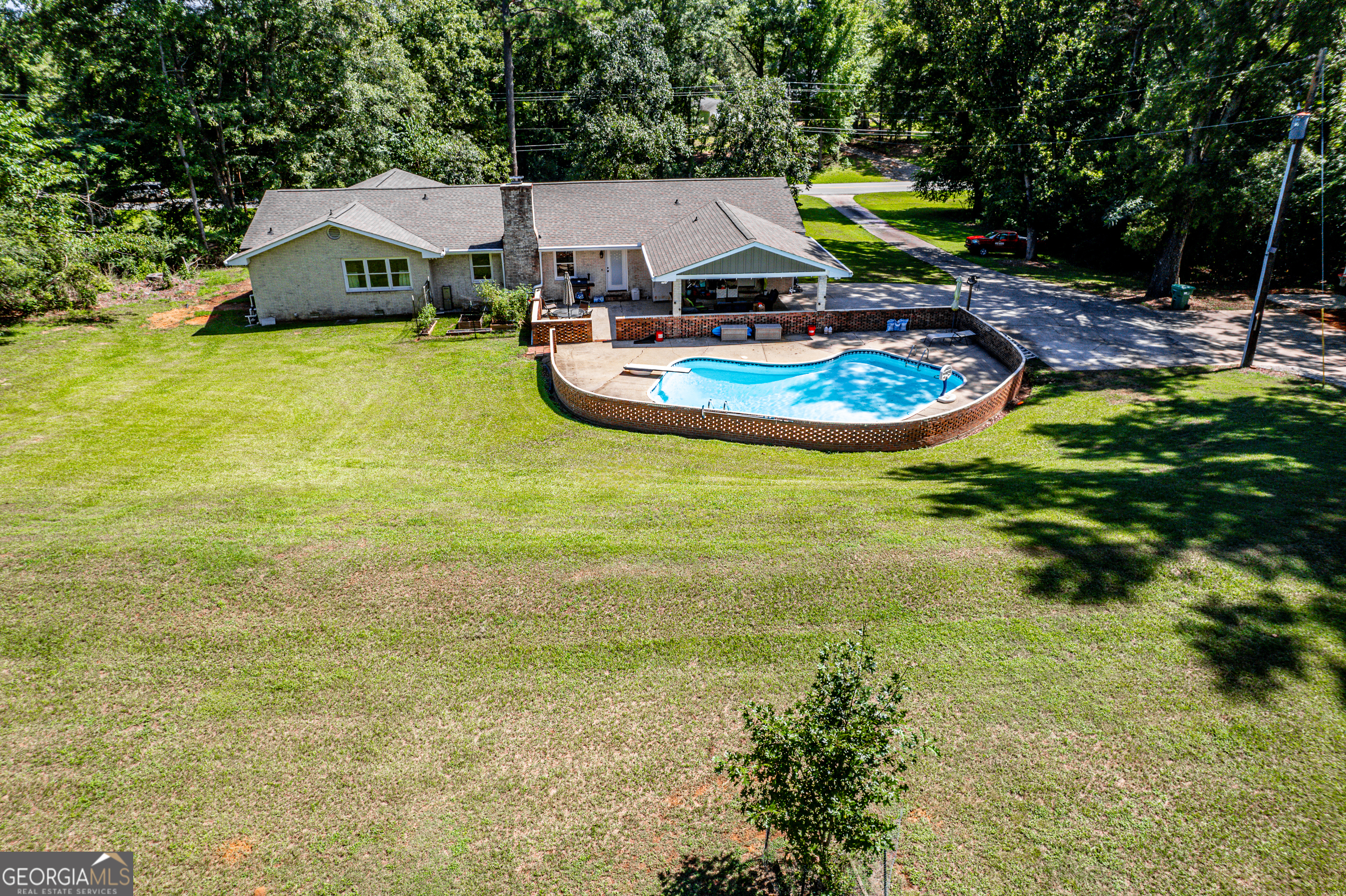 122 Ivey Weaver Road Milledgeville, GA 31061 - Photo 14 of 64 a view of a swimming pool with lounge chairs