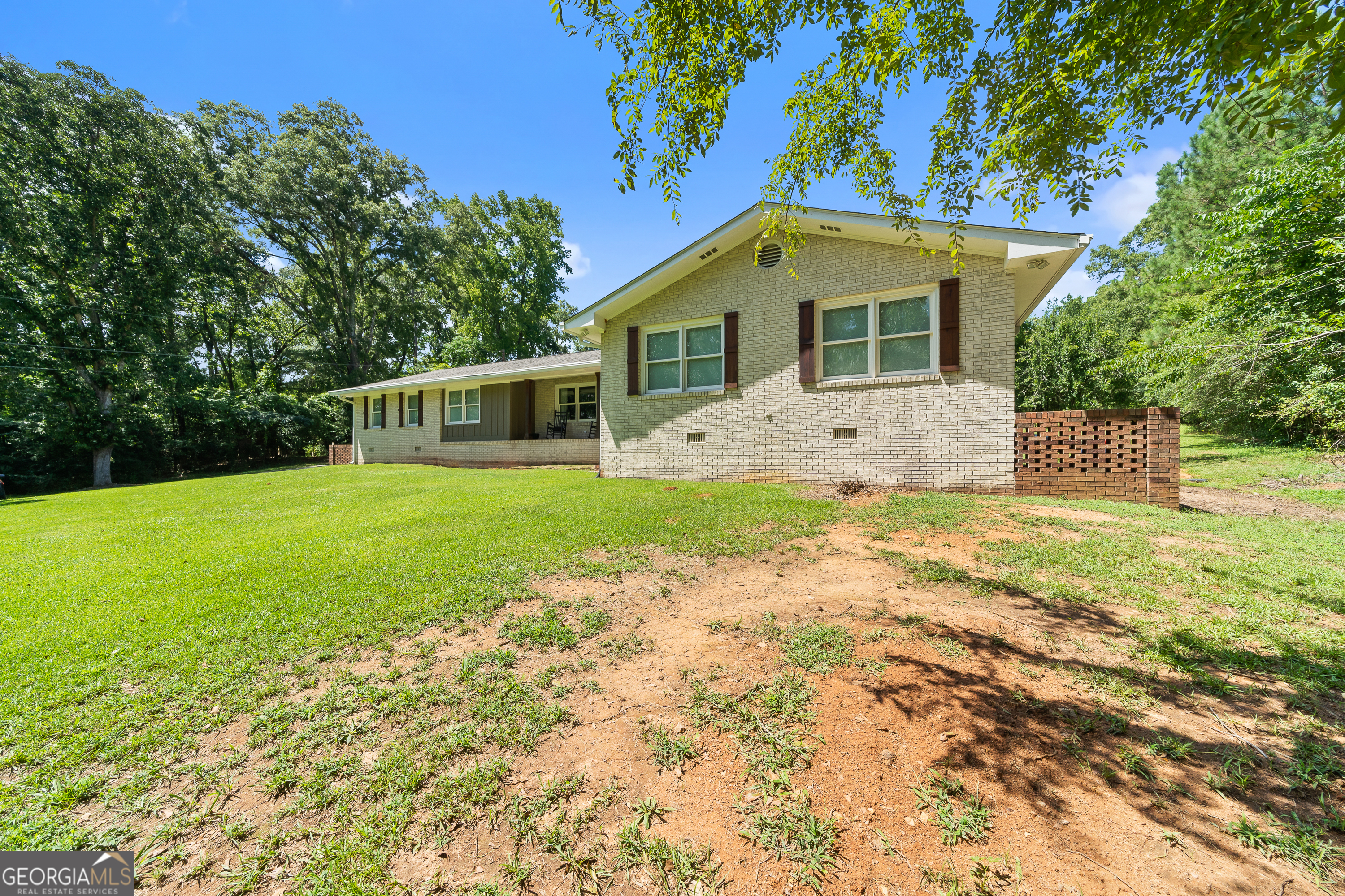 122 Ivey Weaver Road Milledgeville, GA 31061 - Photo 16 of 64 a front view of a house with yard and garage