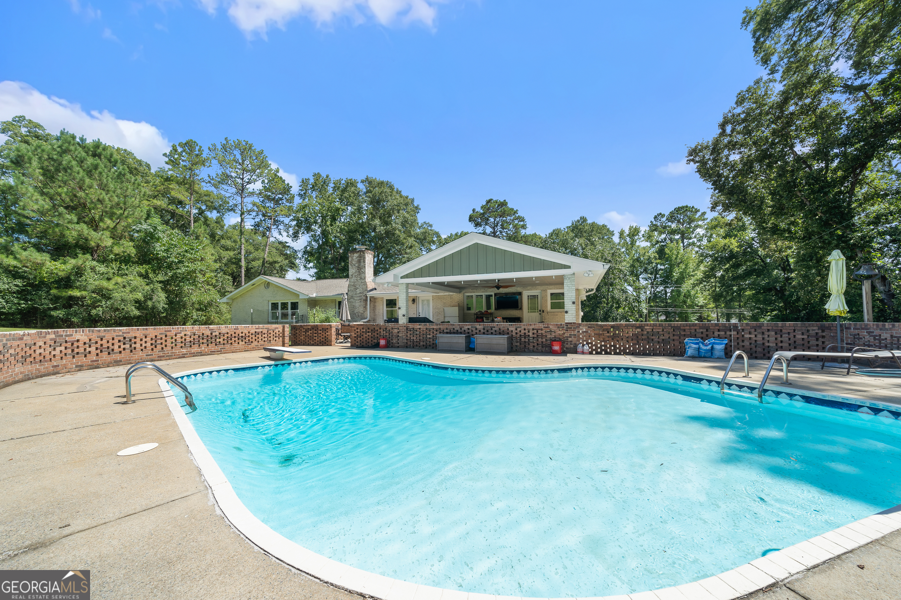 122 Ivey Weaver Road Milledgeville, GA 31061 - Photo 22 of 64 a view of a swimming pool with a patio