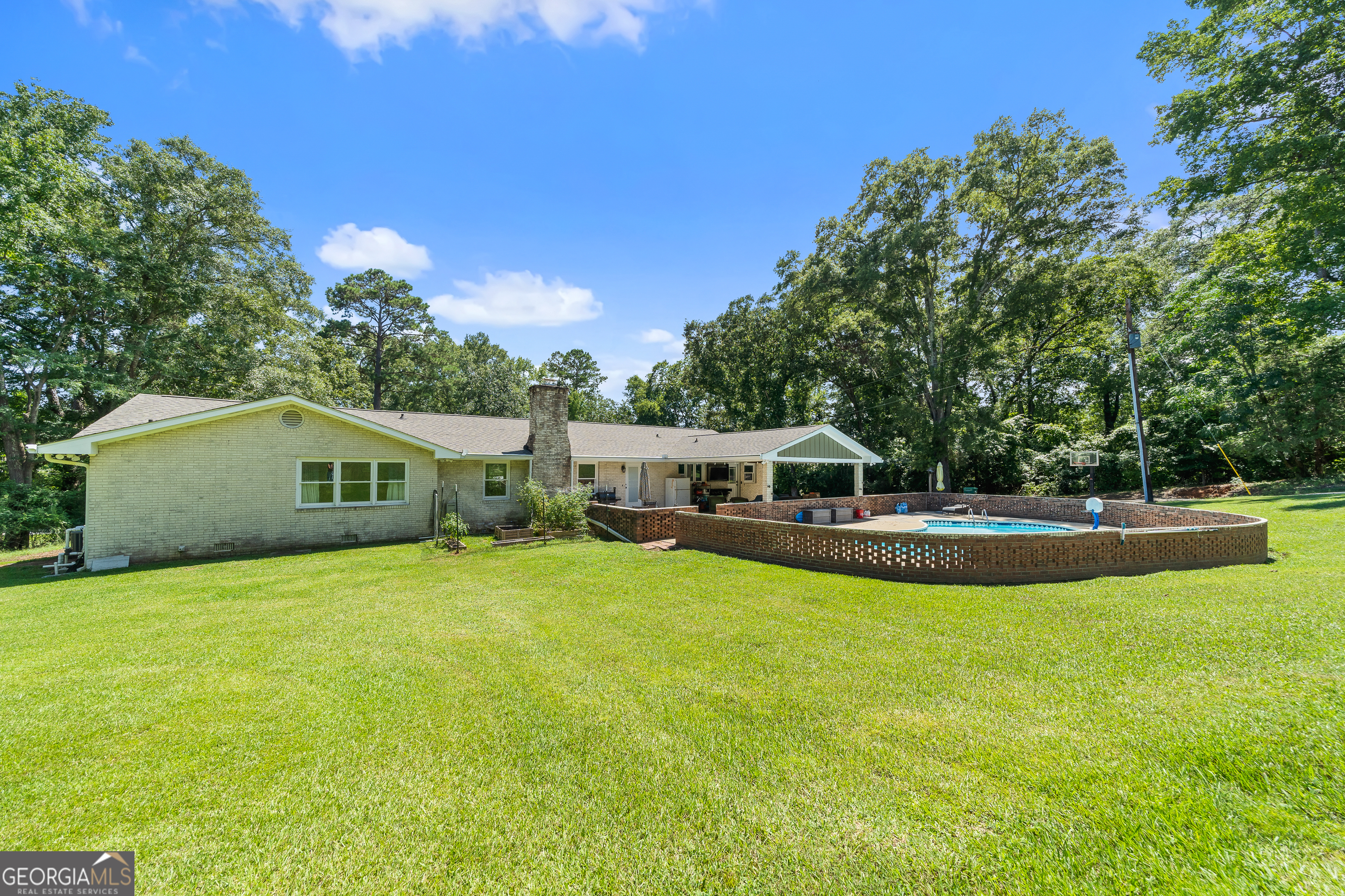 122 Ivey Weaver Road Milledgeville, GA 31061 - Photo 23 of 64 a view of a house with a yard patio and swimming pool