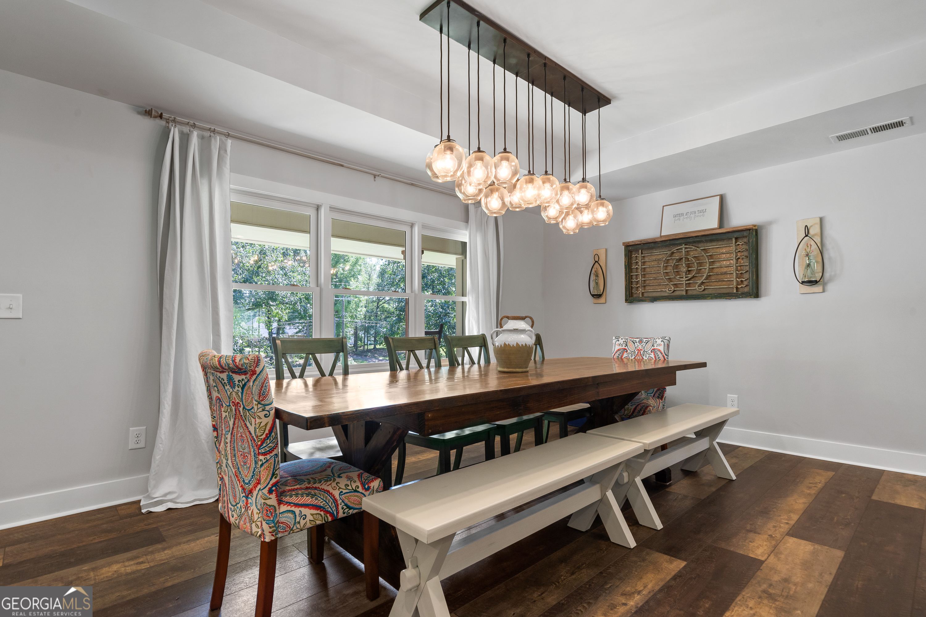 122 Ivey Weaver Road Milledgeville, GA 31061 - Photo 30 of 64 a view of a dining room with furniture a chandelier and wooden floor
