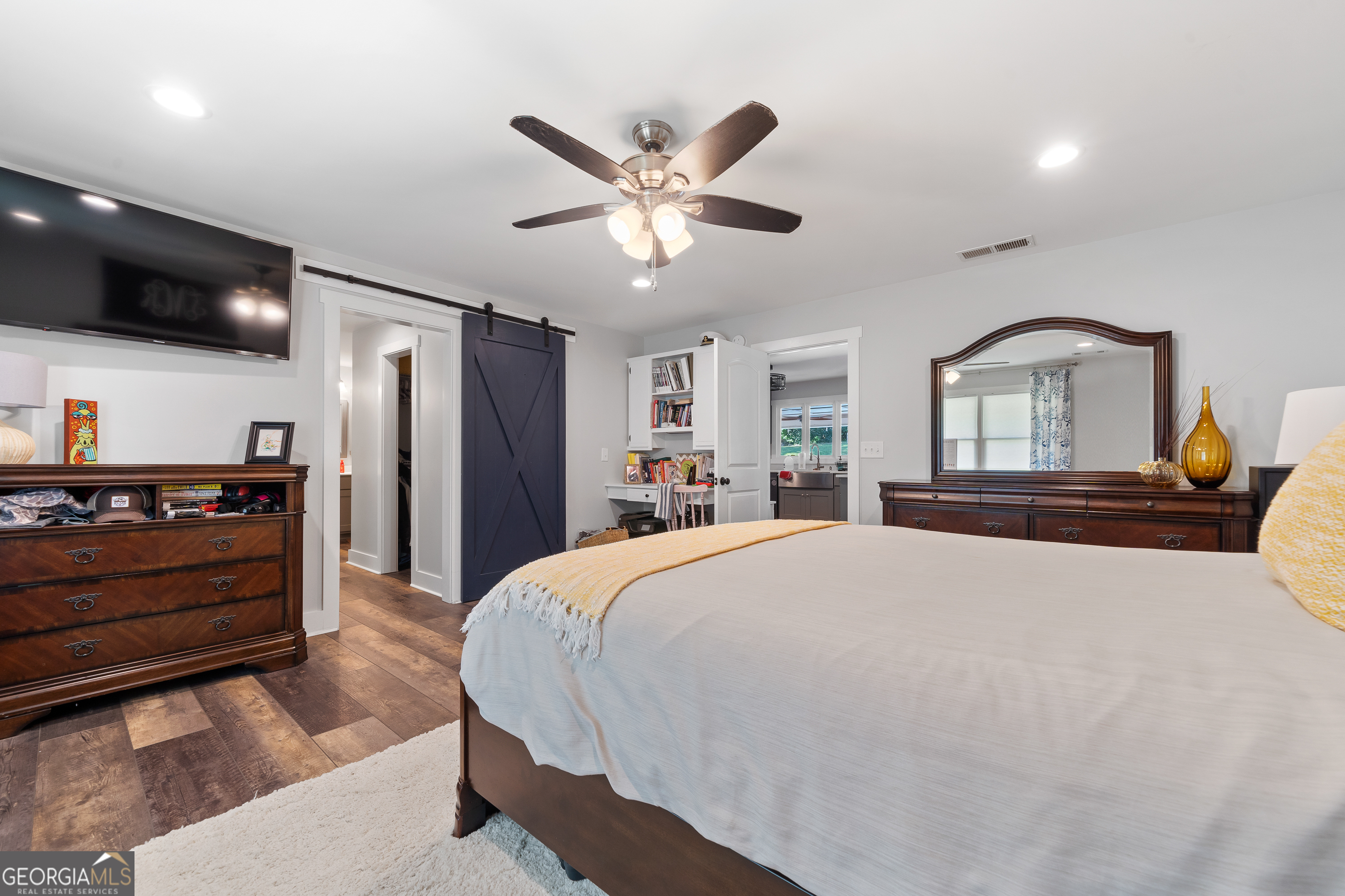 122 Ivey Weaver Road Milledgeville, GA 31061 - Photo 44 of 64 a bed room with a bed and a large mirror