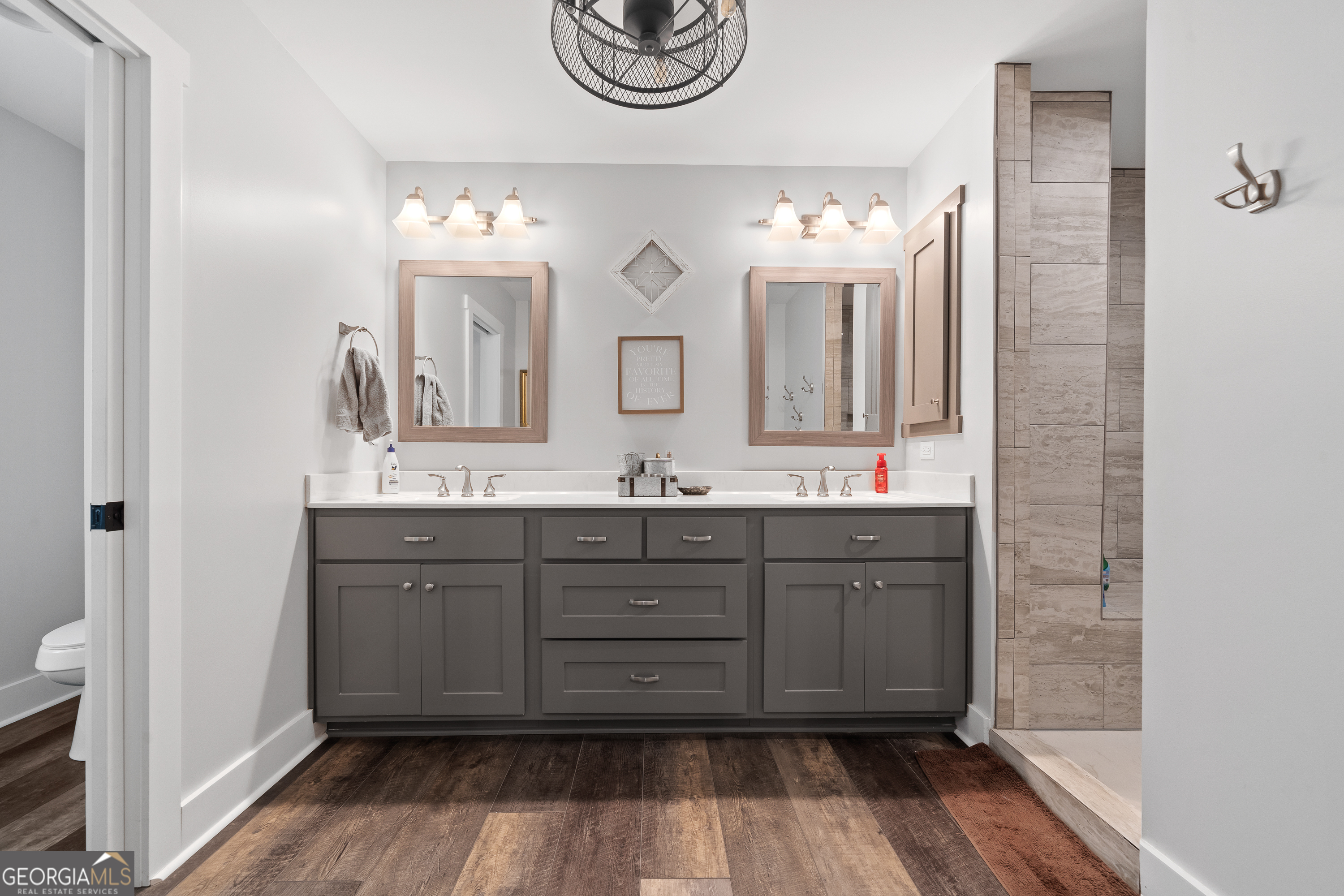 122 Ivey Weaver Road Milledgeville, GA 31061 - Photo 46 of 64 a bathroom with a double vanity sink and a mirror