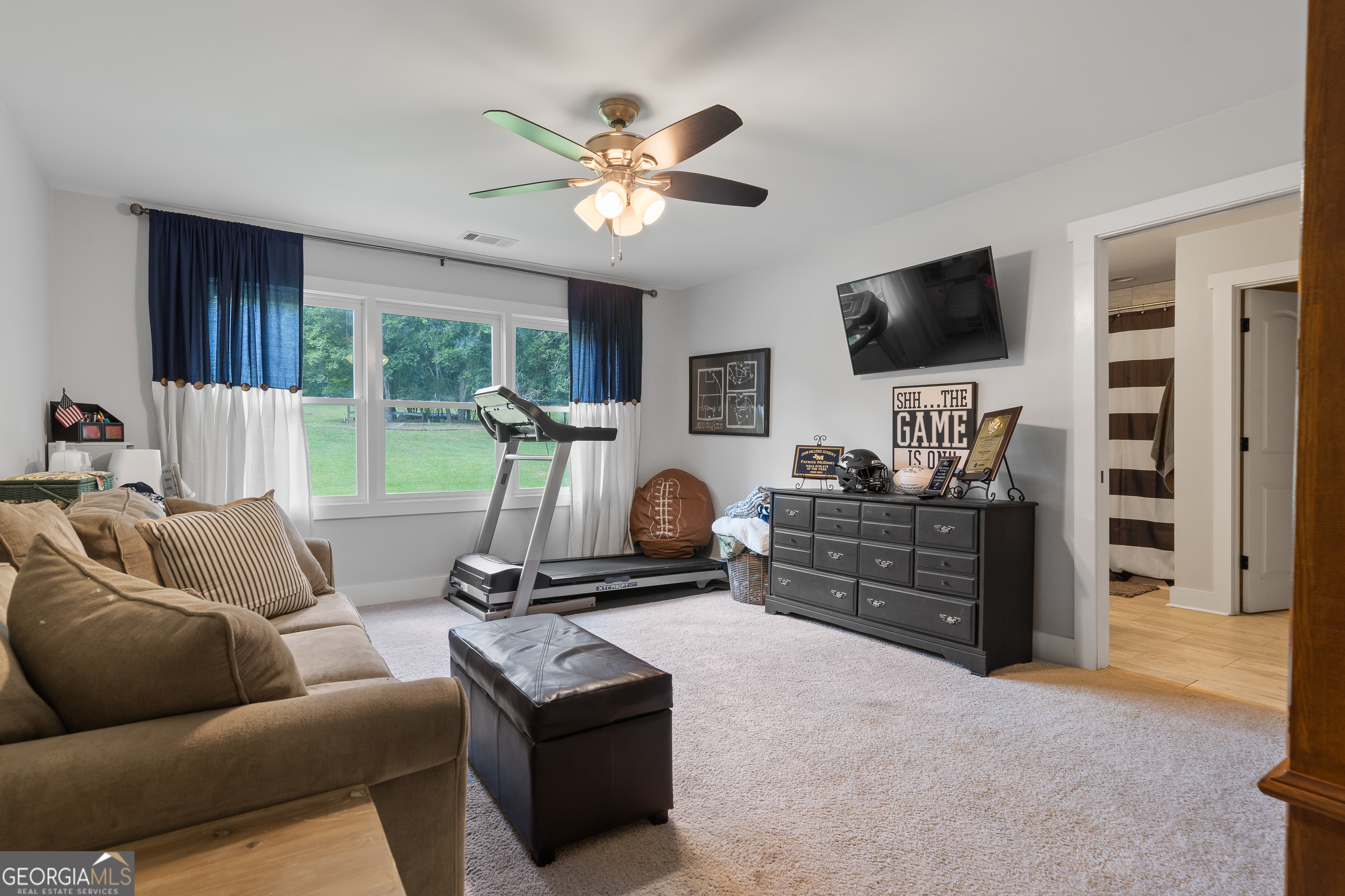 122 Ivey Weaver Road Milledgeville, GA 31061 - Photo 50 of 64 a living room with furniture and a flat screen tv