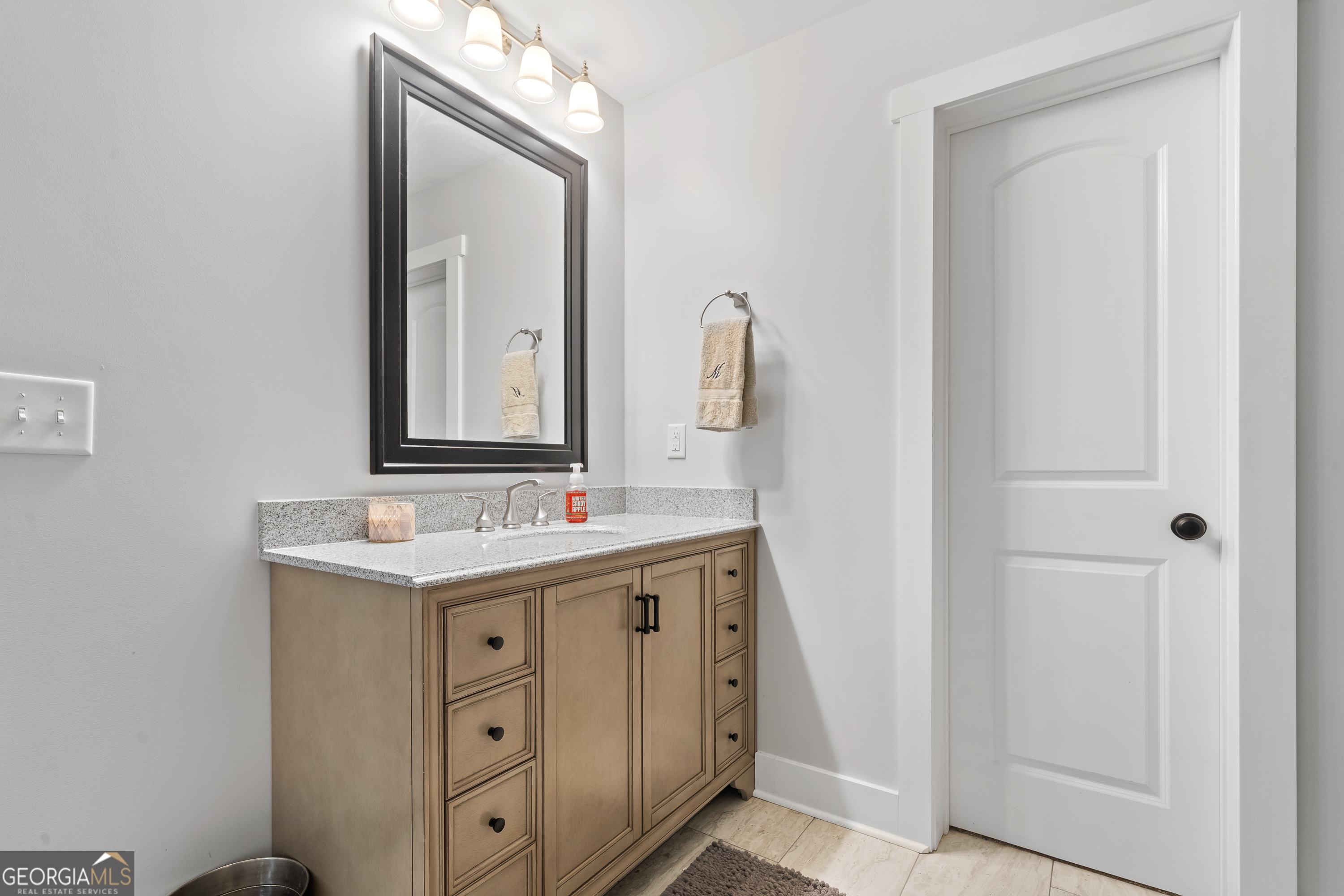 122 Ivey Weaver Road Milledgeville, GA 31061 - Photo 53 of 64 a bathroom with a granite countertop sink vanity and mirror