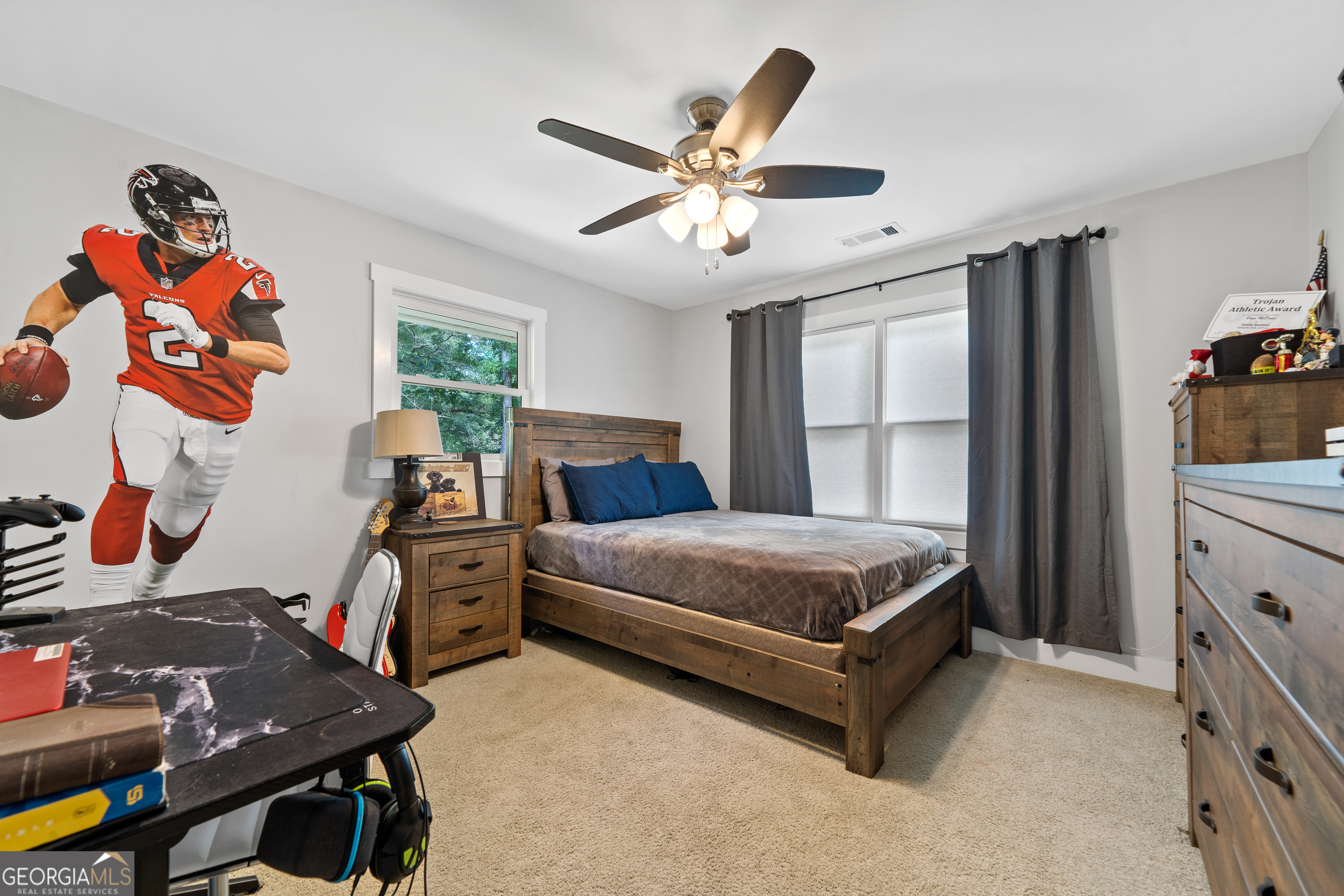 122 Ivey Weaver Road Milledgeville, GA 31061 - Photo 59 of 64 a bedroom with a bed and a chandelier