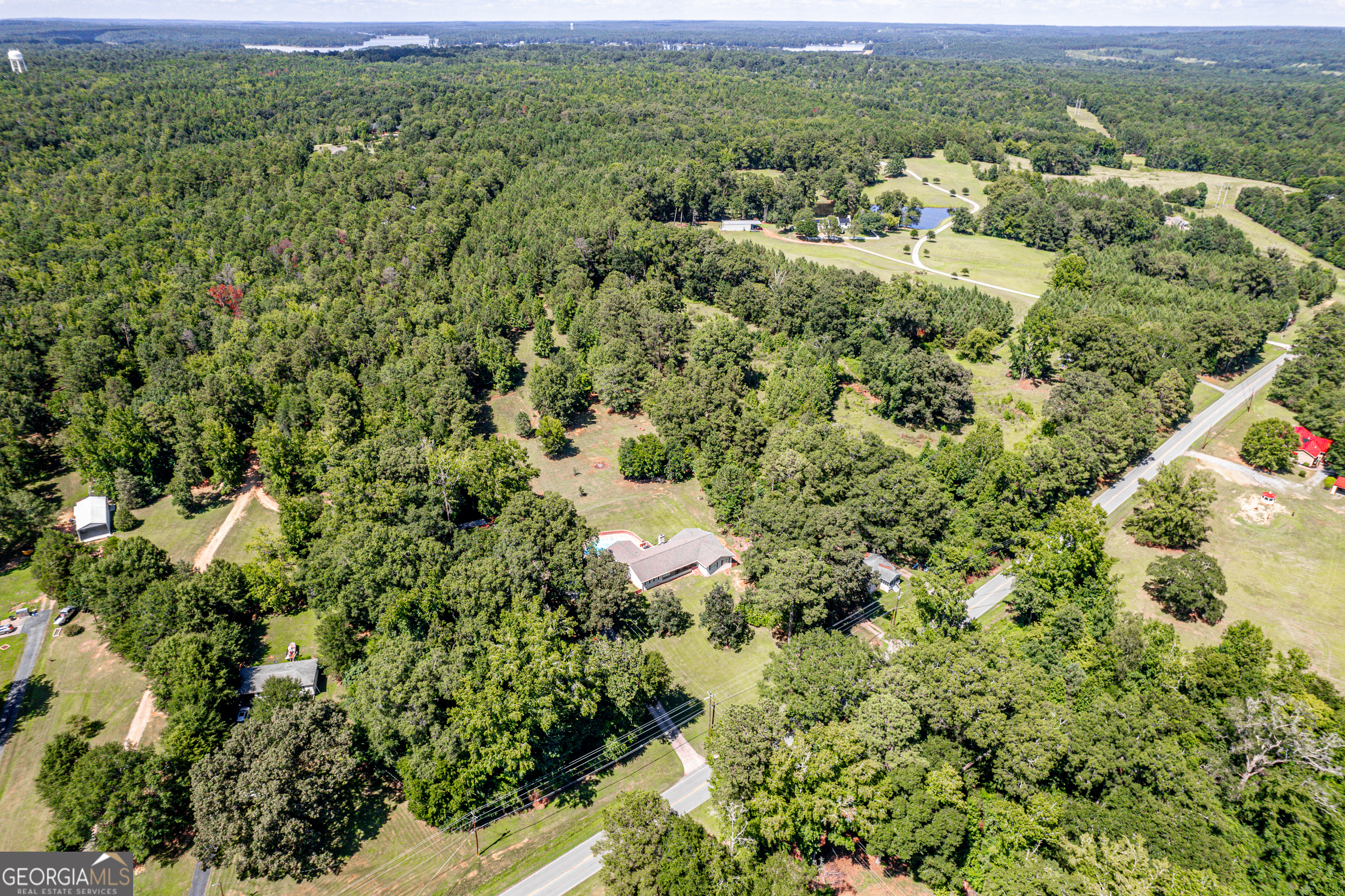 122 Ivey Weaver Road Milledgeville, GA 31061 - Photo 7 of 64 a view of a green field with lots of bushes