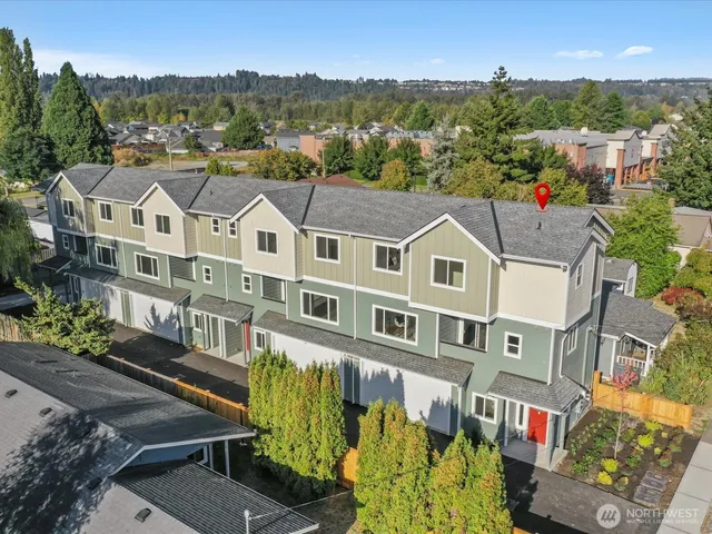 an aerial view of a residential apartment building with a yard