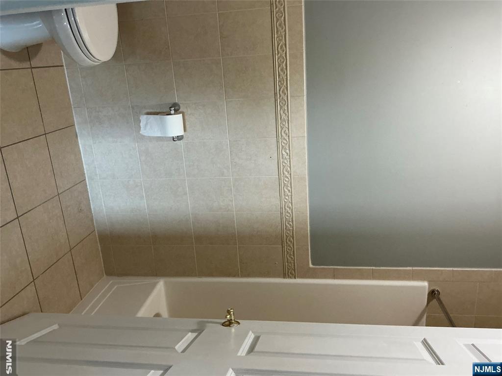 102 Berry Street, Unit 5 Hackensack, NJ 07601 - Photo 8 of 13 a bathroom with a shower