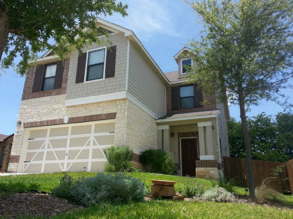 571 New Country Road Kyle, TX 78640 - Photo 1 of 1 a front view of a house with garden