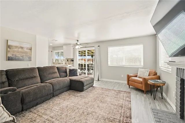 a living room with furniture window and a flat screen tv