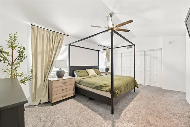 a bedroom with a bed lamp and a window