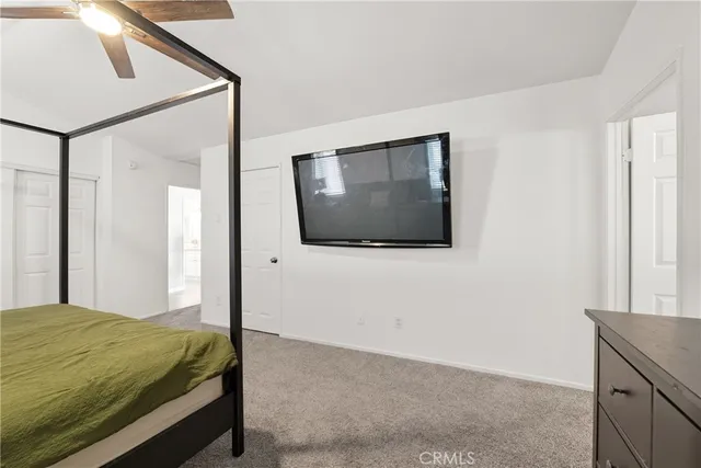 a bedroom with a bed and a mirror
