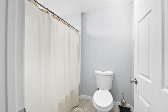 a white toilet sitting next to a small bathroom